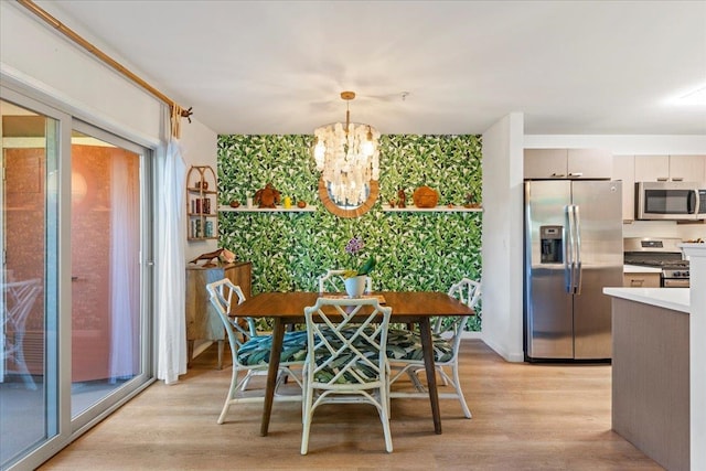 dining room featuring light hardwood / wood-style floors and a notable chandelier