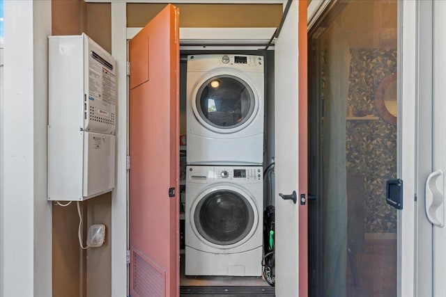 clothes washing area with stacked washer and clothes dryer