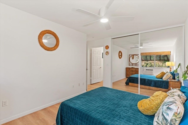 bedroom with ceiling fan, a closet, and light hardwood / wood-style flooring