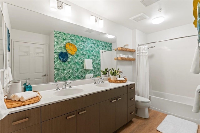 full bathroom featuring vanity, wood-type flooring, shower / tub combo, and toilet