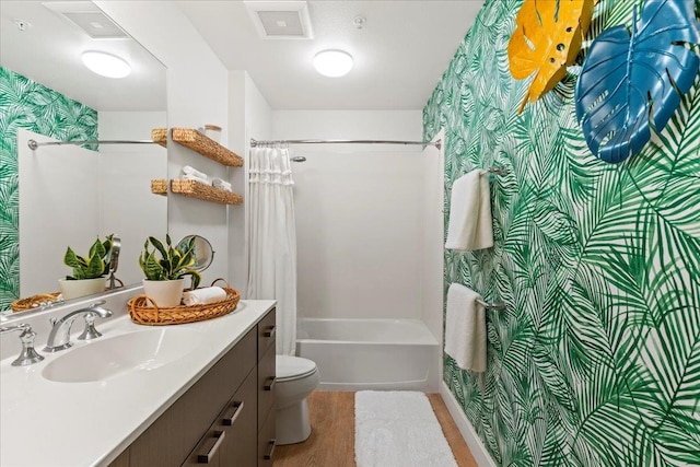 bathroom with hardwood / wood-style floors, vanity, and toilet