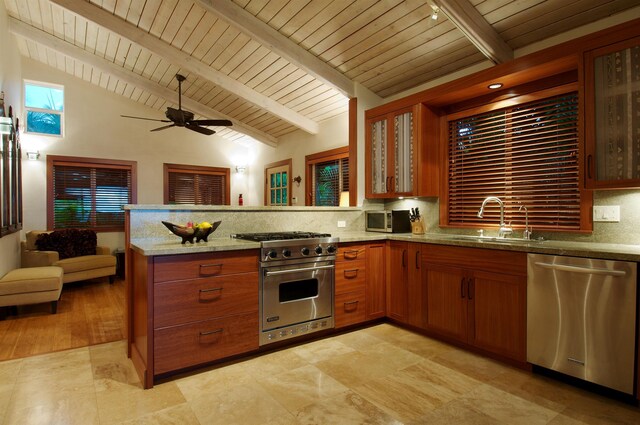 kitchen with lofted ceiling with beams, kitchen peninsula, sink, decorative backsplash, and appliances with stainless steel finishes