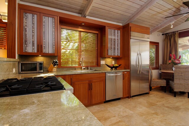 kitchen with stainless steel appliances, vaulted ceiling with beams, sink, light stone counters, and wooden ceiling