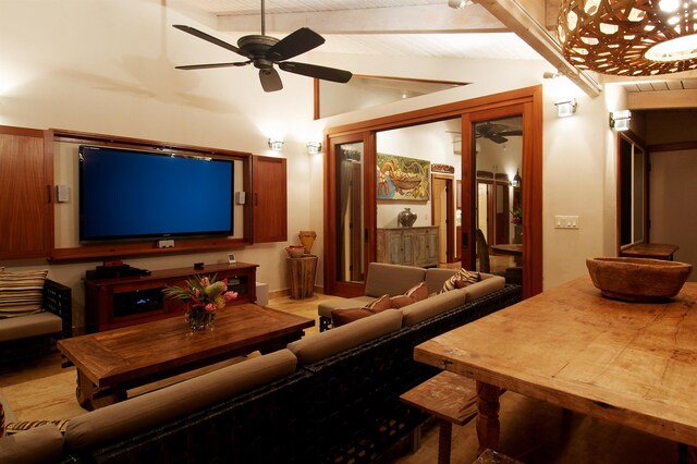 home theater with ceiling fan and lofted ceiling with beams