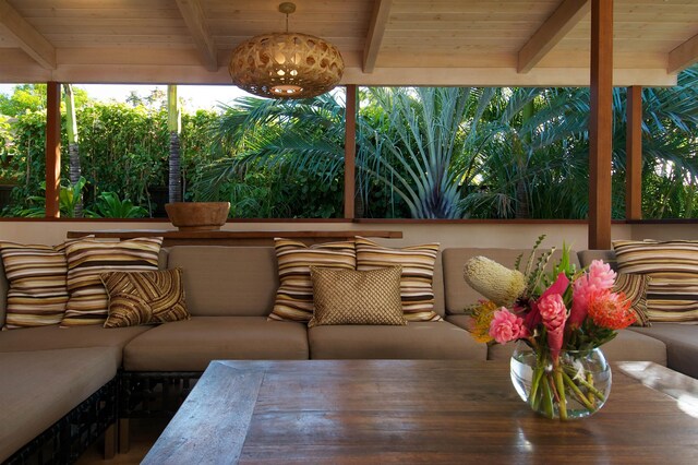 sunroom featuring beamed ceiling