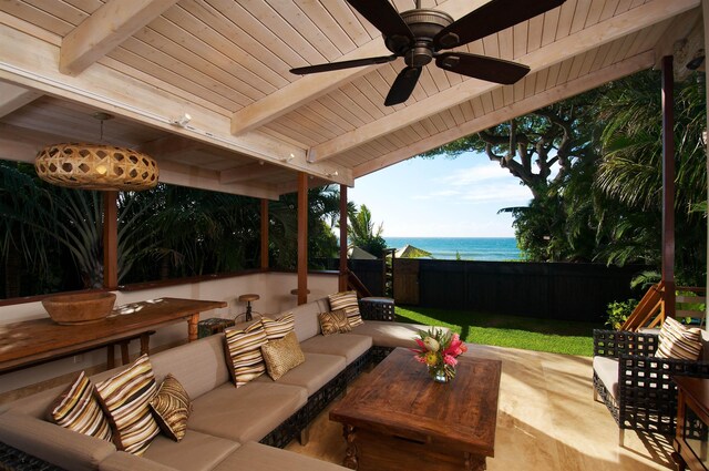 view of patio / terrace featuring ceiling fan, an outdoor living space, and a water view