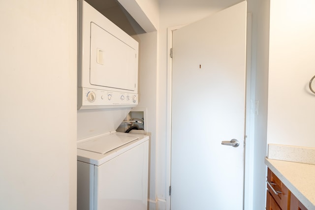 laundry area with stacked washer and clothes dryer