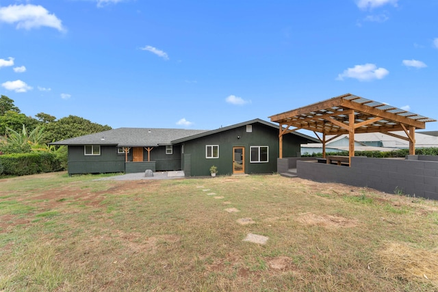 back of house with a lawn and a pergola