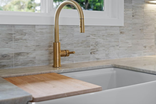 interior details with light countertops, a sink, and white cabinets