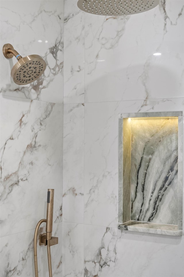 room details featuring a marble finish shower