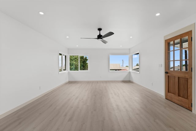 interior space featuring recessed lighting, light wood finished floors, baseboards, and a ceiling fan
