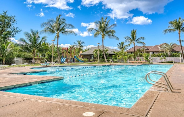 view of pool with a playground