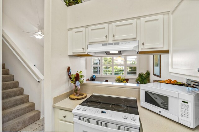 tiled dining space featuring lofted ceiling