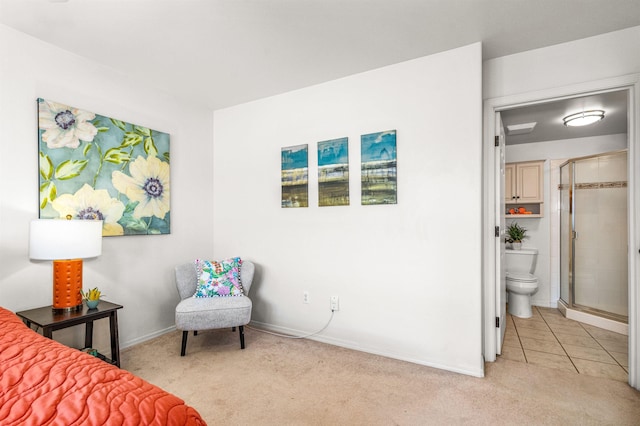 bedroom featuring light colored carpet and ensuite bath