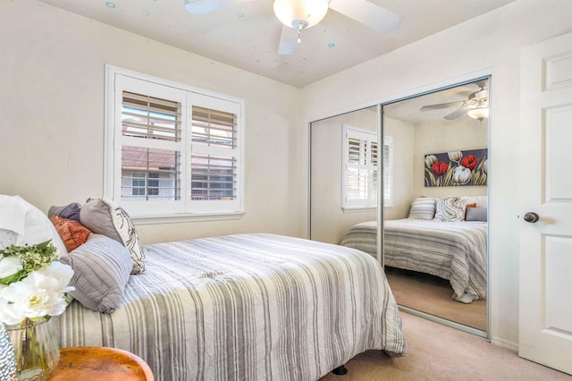 bedroom with a closet, ceiling fan, light carpet, and multiple windows