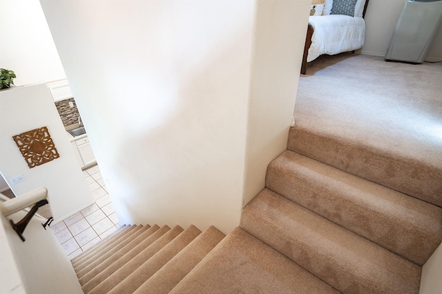 staircase with tile patterned floors