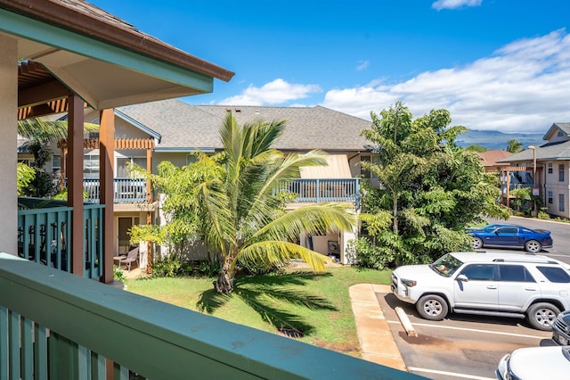 exterior space with a balcony and a yard