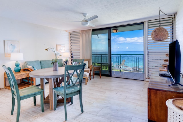 2142 Iliili Rd Unit 303, Kihei, HI 96753 - dining space featuring floor to ceiling windows, a ceiling fan, and a textured ceiling
