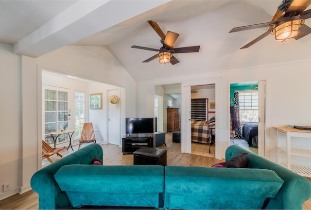 living room with ceiling fan, lofted ceiling, and light hardwood / wood-style floors