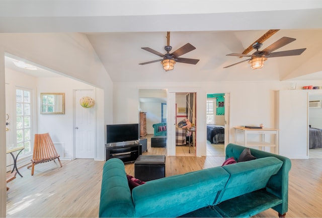 living room featuring light hardwood / wood-style floors and vaulted ceiling with beams