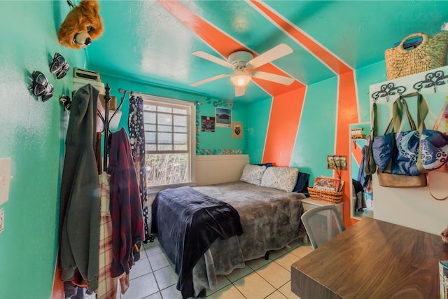 tiled bedroom featuring ceiling fan