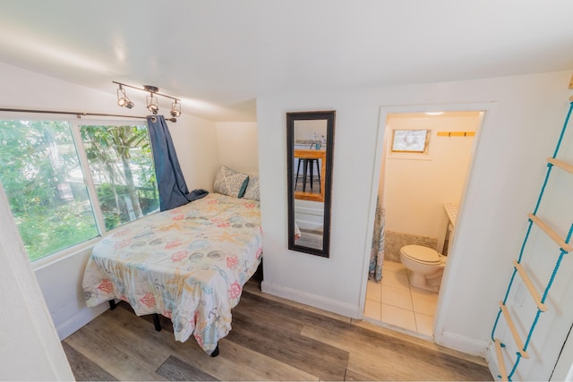 bedroom featuring wood-type flooring and connected bathroom