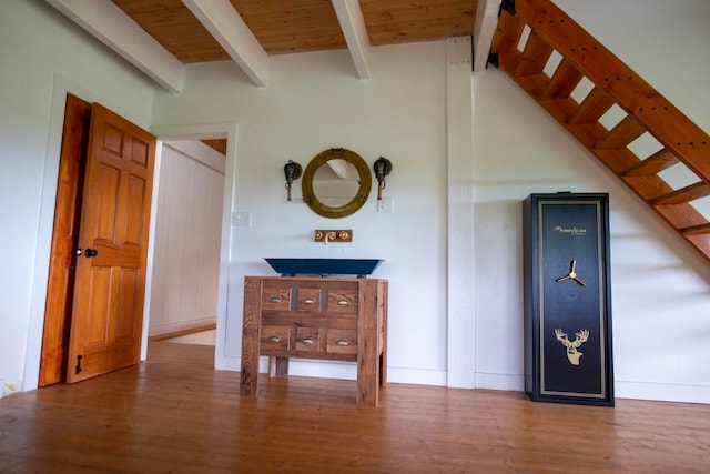 interior space with wooden ceiling, stairway, wood finished floors, and lofted ceiling with beams