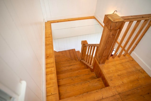 stairs featuring wood-type flooring