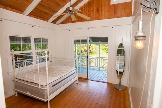 bedroom featuring hardwood / wood-style floors, access to exterior, beamed ceiling, and wood ceiling