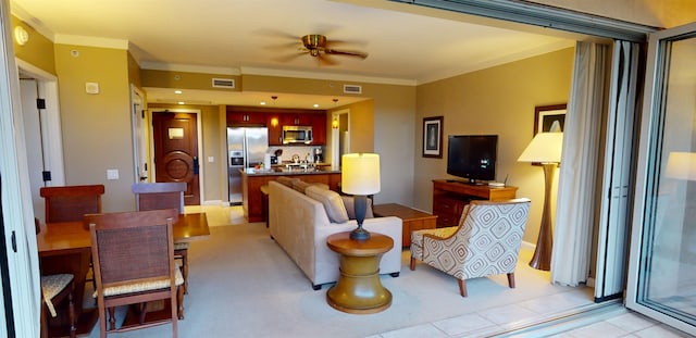 living room with ceiling fan, crown molding, and light tile patterned floors