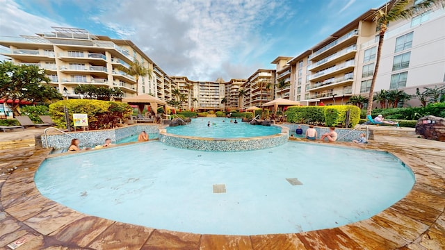 view of swimming pool with pool water feature