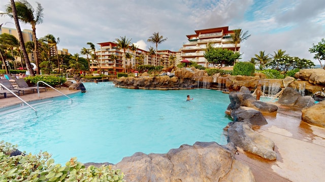 view of swimming pool with pool water feature