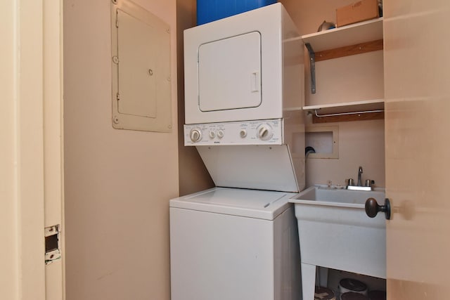 washroom featuring sink, stacked washer / drying machine, and washer hookup