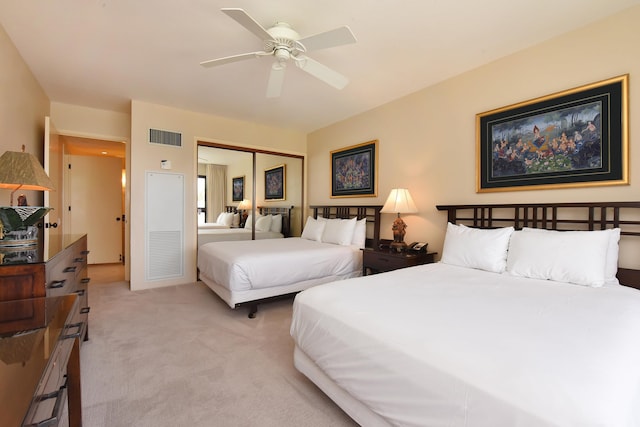 carpeted bedroom with a closet and ceiling fan