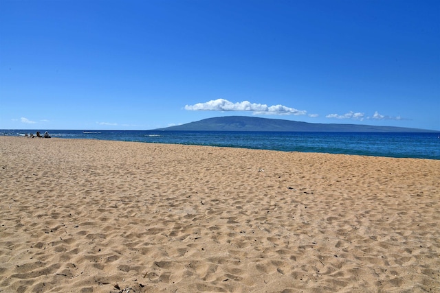 exterior space with a water view and a beach view