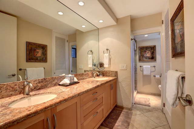 bathroom with vanity, toilet, a shower with shower door, and tile patterned flooring