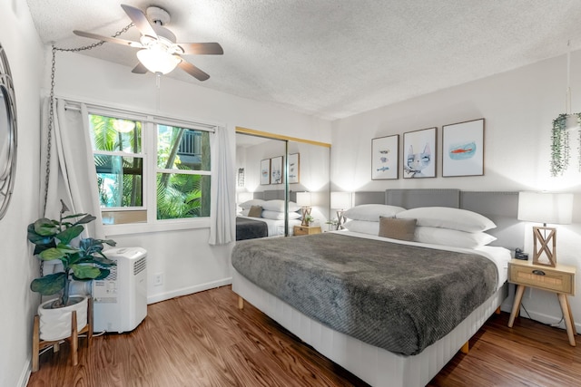 bedroom featuring ceiling fan, a closet, a textured ceiling, and hardwood / wood-style flooring