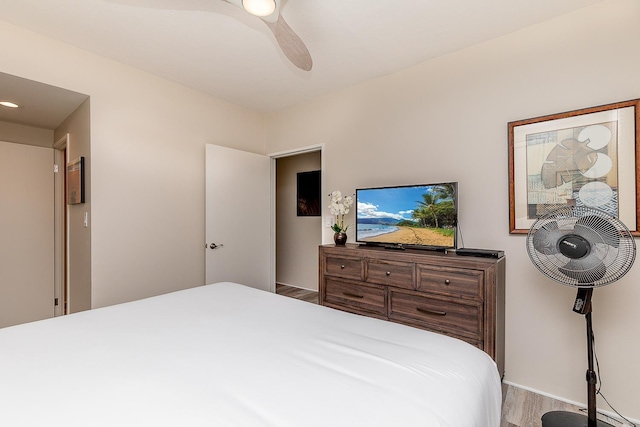 bedroom with ceiling fan and wood-type flooring