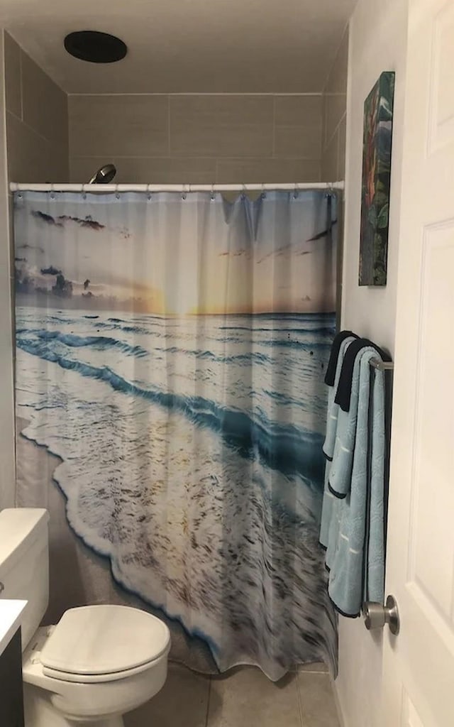 bathroom with tile patterned flooring, vanity, a shower with curtain, and toilet