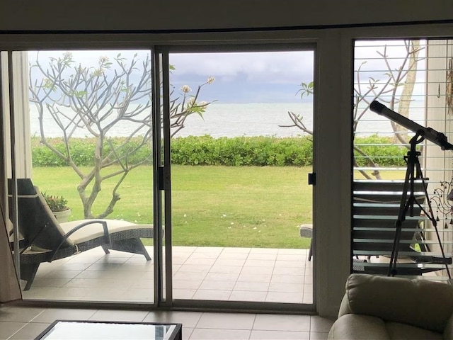 doorway to outside featuring light tile patterned flooring and a water view