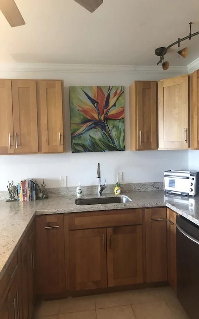 kitchen featuring light stone countertops, sink, stainless steel dishwasher, and light tile patterned floors