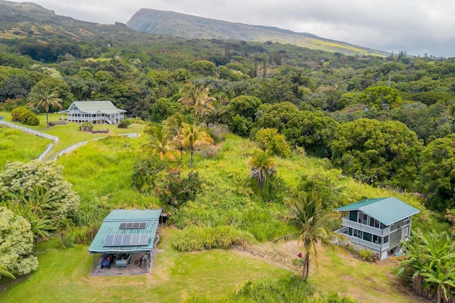 aerial view with a wooded view and a mountain view