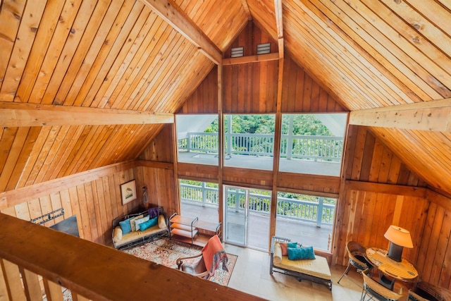 living room featuring lofted ceiling, a healthy amount of sunlight, wood walls, and wooden ceiling