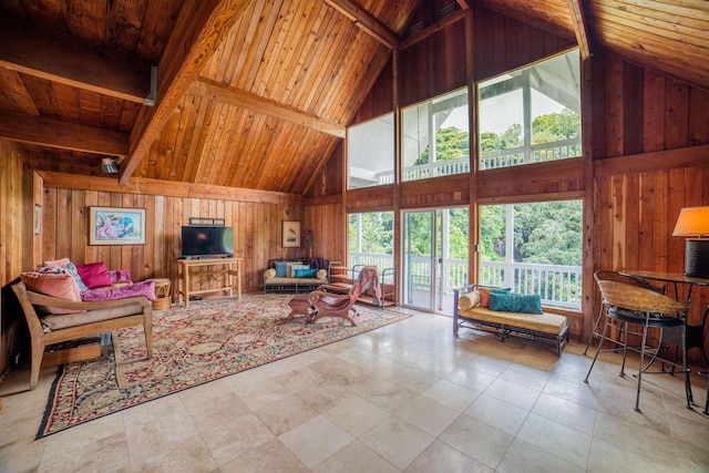 living room with wood ceiling, wood walls, tile patterned flooring, and high vaulted ceiling