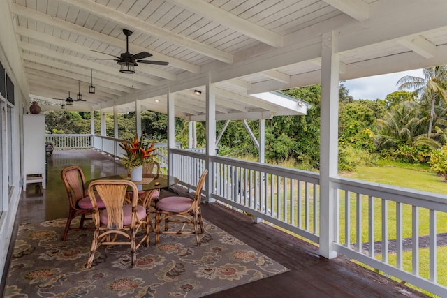 deck featuring a yard, outdoor dining area, and ceiling fan