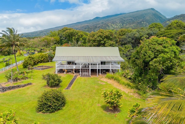 aerial view featuring a wooded view and a mountain view