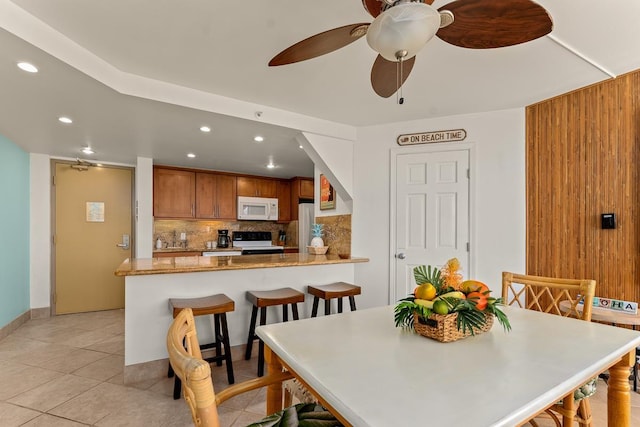 dining area with light tile patterned floors, ceiling fan, and recessed lighting