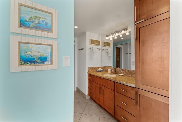 bathroom with tile patterned flooring, vanity, and baseboards