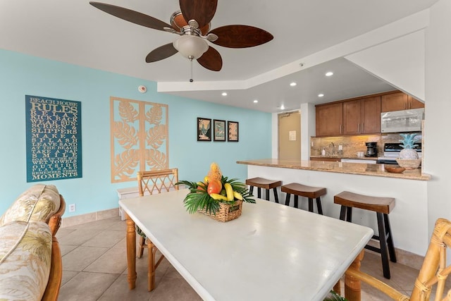 dining area with recessed lighting, ceiling fan, baseboards, and light tile patterned floors