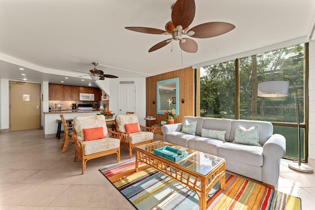 living area featuring light tile patterned floors, a ceiling fan, and recessed lighting